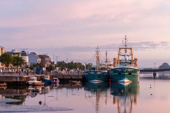 The seaport in Wexford, Ireland with several fishing boats docked.
