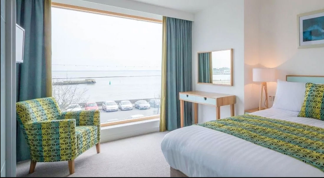 A bedroom at Talbot Suites in Wexford with a view of the harbor.